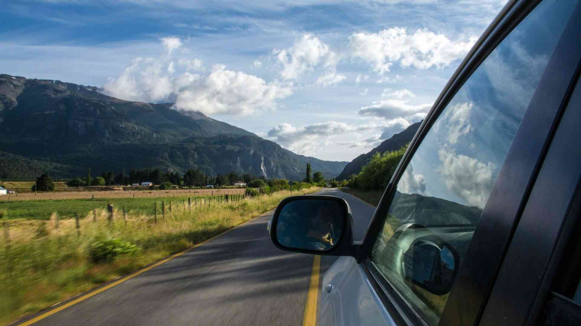 Private car driving on an open road — LocalsRide transfer services worldwide